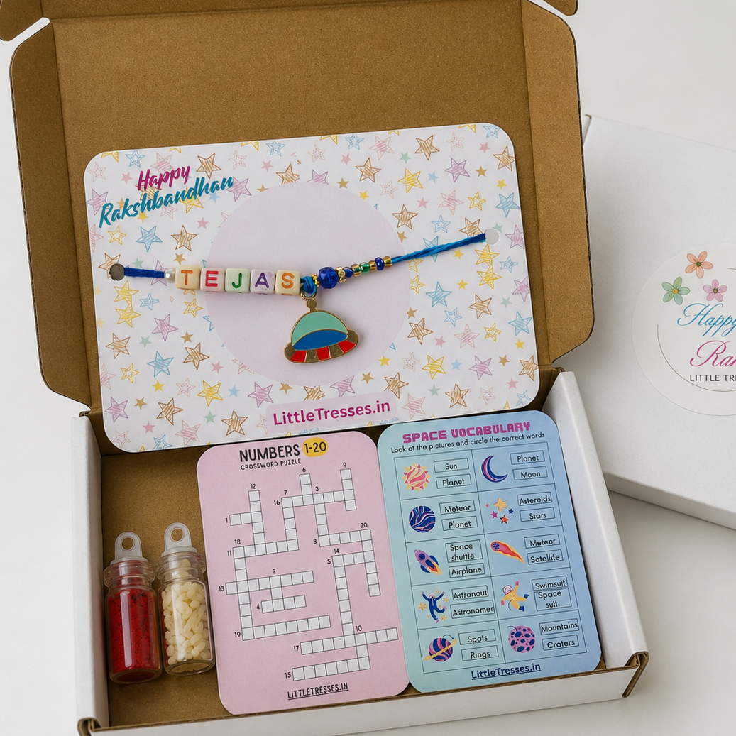Celebrate Raksha Bandhan with the Little Tresses Personalized Spaceship Rakhi Gift Box. Includes a custom name spaceship Rakhi, educational activity cards, greeting card, roli bottle and rice bottle in a premium gift-ready box.