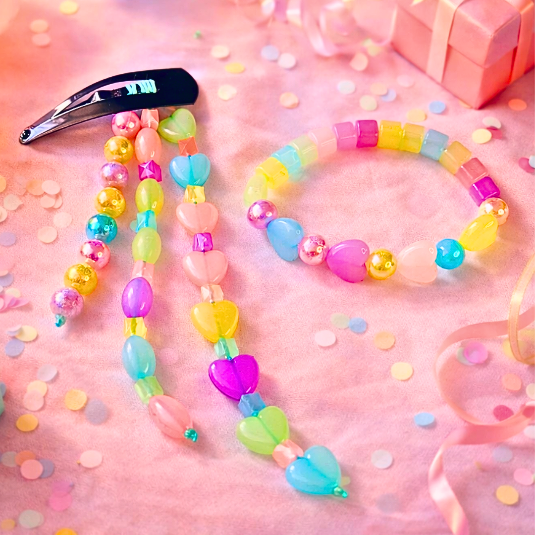 Girl wearing pastel heart snap hair clip with matching beaded bracelet set