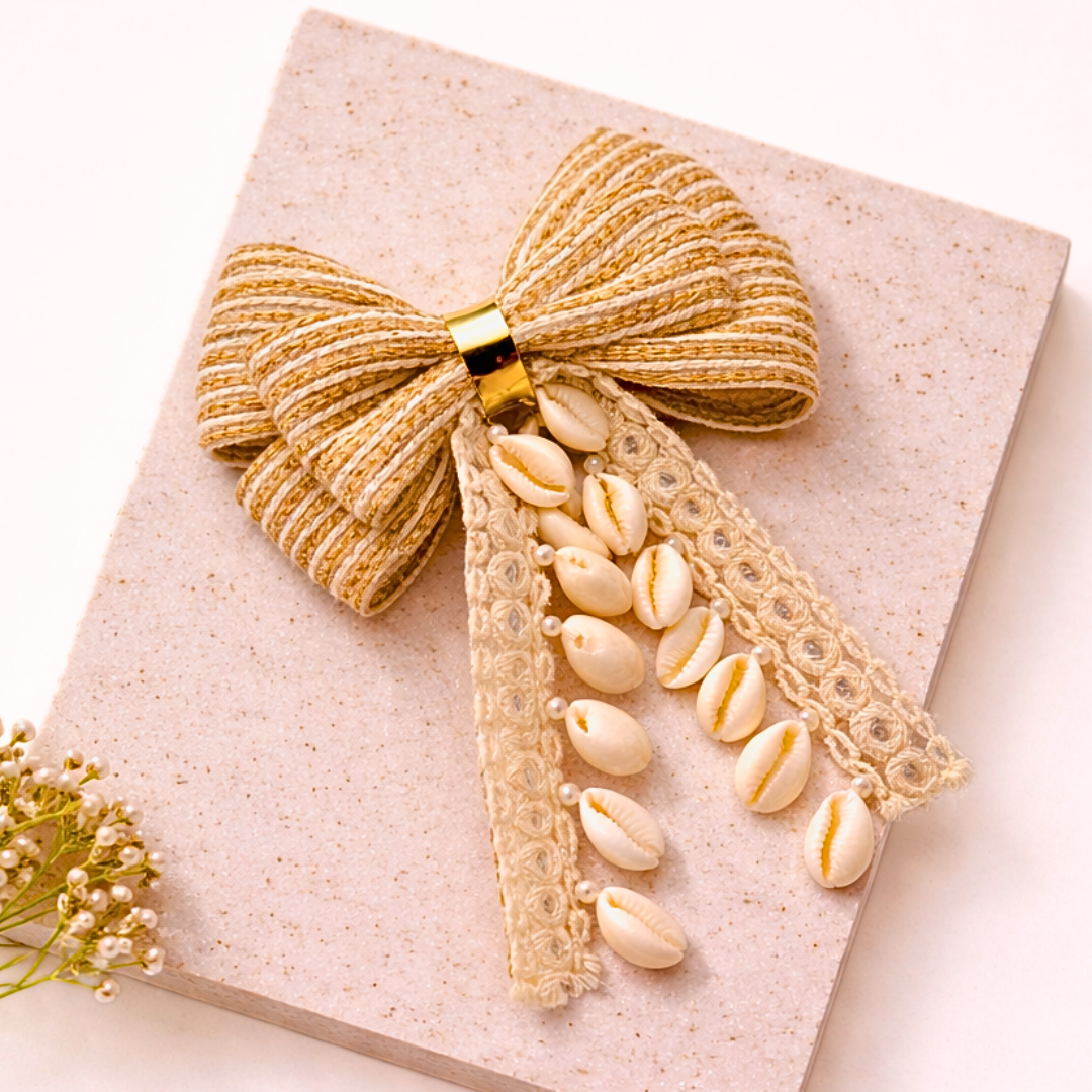 Decorative bow and shell embellishments on a light background