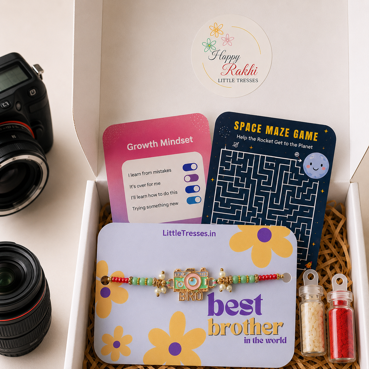 Premium Camera Enthusiast Bro Rakhi Gift Box featuring a camera-themed Rakhi, greeting cards, roli bottle and rice bottle for boys aged 5 years and above.